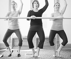 three ladies at a ballet barre